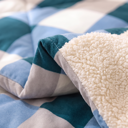 Close-up of the Blue Check quilt: teal and blue check velvet meeting thick cream sherpa fleece