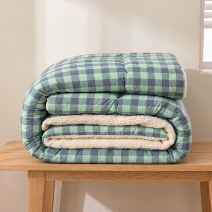 Green Check quilt folded on an oak bench, showing the depth and loft of the filling