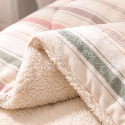 Close-up of the Pastel Stripe quilt: cream striped velvet meeting thick cream sherpa fleece